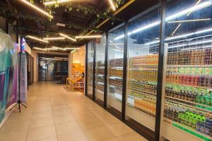 a aisle of a store with glass doors and shelves at Kozi Square New SGH Cozy Home LV5B in Kuching