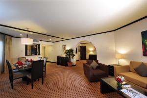 a living room with a couch and a table at Hotel Borobudur Jakarta in Jakarta