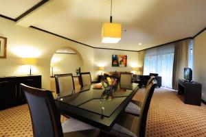 a dining room and living room with a table and chairs at Hotel Borobudur Jakarta in Jakarta