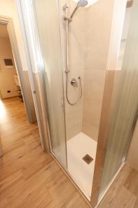 a shower with a glass door in a bathroom at Rossini15 - garage privato in Alba +24 photos