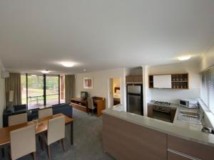 a living room with a kitchen and a dining room at Margarets In Town Apartments in Margaret River Town