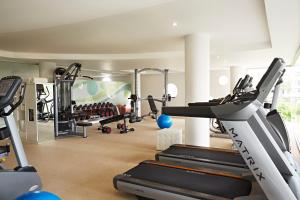 a gym with treadmills and machines in a room at Double - Six, Luxury Hotel - Seminyak in Seminyak
