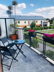 a patio with a table and chairs on a balcony at Modern Apartment Disneyland Paris in Chessy