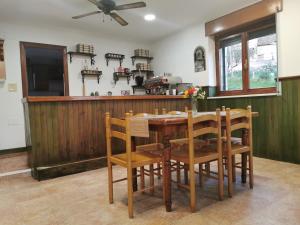 a kitchen with a wooden table and chairs at Casa pando 49 in Pando +31 photos