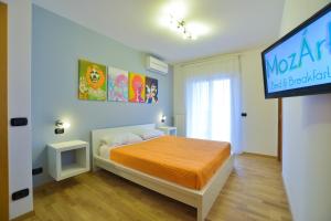 Ένα ή περισσότερα κρεβάτια σε δωμάτιο στο MozÁrt Bed & Breakfast - Affittacamere