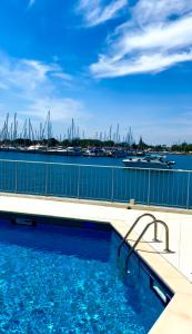 a swimming pool with a view of a marina at LE PANORAMIQUE cap d’agde in Cap d'Agde