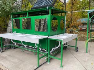a green structure with two sinks in a park at Tisza beach Wild Camping 2 in Szeged +19 photos