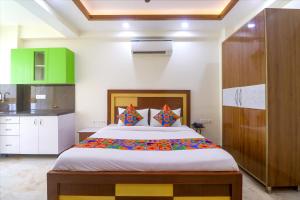 a bedroom with a large bed in a room at FabHotel Star Corporate Suite in Gurgaon
