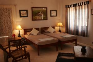 a bedroom with two beds and a table and chairs at Korta Escape- A Heritage Resort in Jawai in Korta