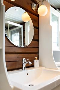 a bathroom with a sink and a mirror at Utsikten in Sykkylven