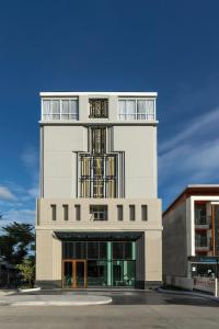 a tall building with a balcony on top of it at Kantary Hotel Banchang in Ban Chang