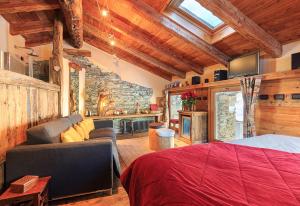 a bedroom with a bed and a stone wall at Locanda4 in Valtournenche