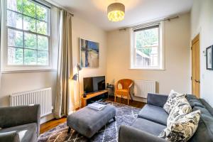 sala de estar con sofá y TV en Middlethorpe Manor - No 6 Tranquility & Ease en York