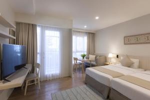 Postel nebo postele na pokoji v ubytování Kantary Hotel Banchang