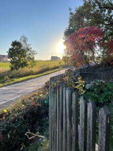 a wooden fence on the side of a road at Horské Apartmány Bílý Vlk in Vaclavov u Bruntalu