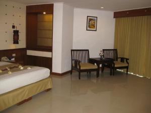 Ein Bett oder Betten in einem Zimmer der Unterkunft Royal Twins Palace Hotel