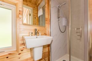 a bathroom with a sink and a shower at Berehaven Pods in Castletownbere