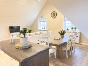a kitchen and dining room with a table and chairs at Kristinsson Apartments second floor in Grindavík