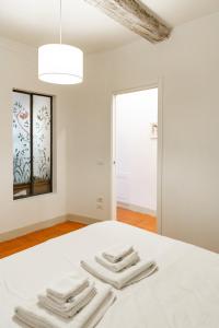 a bedroom with a white bed with towels on it at Graceful apartment in the heart of Florence in Florence