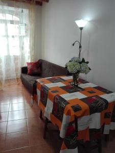 a living room with a table and a couch at Moradia Machado in Topo