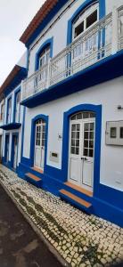 a blue and white building on a street at Moradia Machado in Topo