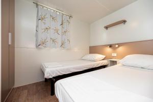 Cama ou camas em um quarto em Camping Kozarica Mobile Homes