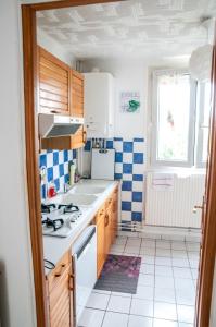 a kitchen with a stove and a sink at Flosoleil in Beauvais