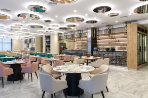 a restaurant with tables and chairs and a bar at Premier Hotel Odesa in Odesa