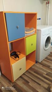 a laundry room with a washer and a washing machine at Апартаменты на Пушкина, 13 in Perm