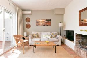 ein Wohnzimmer mit einem Sofa und einem Tisch in der Unterkunft Don Cayo Resort in Altea la Vieja