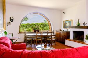 a living room with a red couch and a table at Agriturismo Cavalierino in Montepulciano