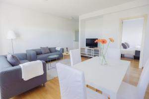 a living room with a couch and a table with flowers on it at Cornisa Apartments in Patalavaca