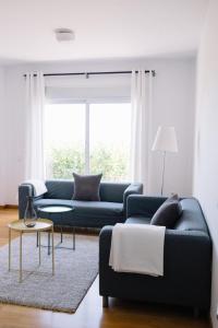a living room with a couch and a table at Cornisa Apartments in Patalavaca