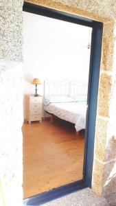 a bedroom with a bed in a room with a window at Casa dos Castaños in O Grove
