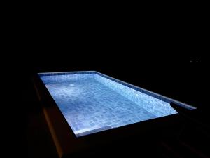 a swimming pool with blue tiles on top of it at Villa Riba in Lun