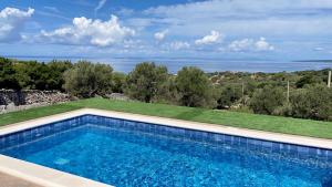 a swimming pool in a yard with a view of the ocean at Villa Riba in Lun +6 photos