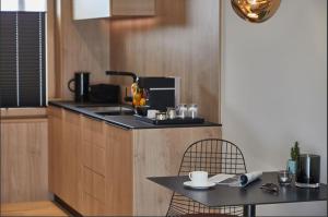 a kitchen with a sink and a table with chairs at Kaiser 4 in Norderney