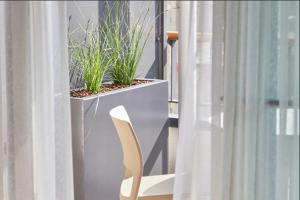 a white chair sitting in front of a window at Kaiser 4 in Norderney