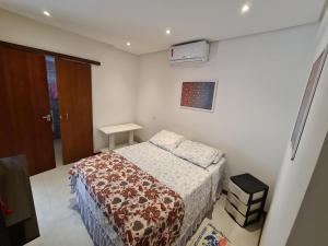 a small bedroom with a bed in a room at Vilage novo em praia do forte 4 in Praia do Forte