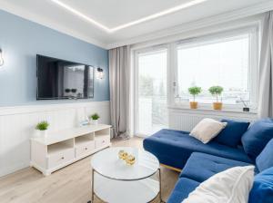 Televízia a/alebo spoločenská miestnosť v ubytovaní Apartament Bliżej Morza Premium I