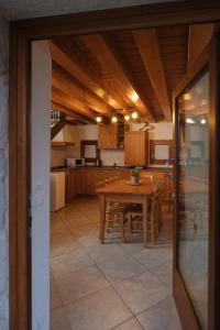 cocina y comedor con mesa de madera en Albergo Diffuso Polcenigo Casa Blas, en Polcenigo