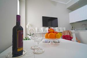 a bottle of wine sitting on a table with two glasses at Chic Apartment in San Babila in Milan