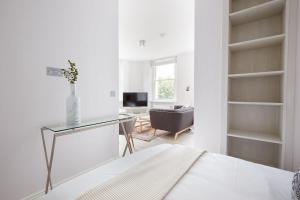 a white room with a desk and a chair at 4VH Virginia House, 31 Bloomsbury Way By City Living London in London