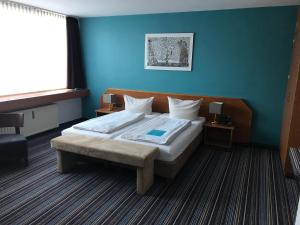Postel nebo postele na pokoji v ubytování Hotel Servatius