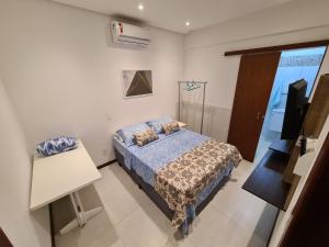 a bedroom with a bed and a television in it at Vilage novo praia do forte 3 in Mata de Sao Joao