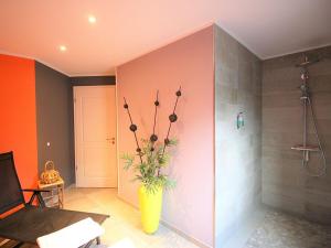 a bathroom with a yellow vase with a plant in it at Ferienhaus Küstenhaus Wremen in Wremerbüttel +14 photos