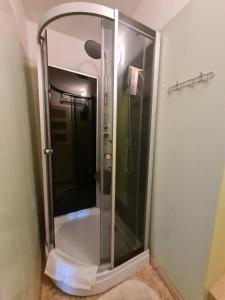 a bathroom with a shower stall and a glass door at Krimuldas Muiža in Sigulda