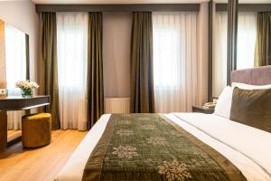 a hotel room with a large bed and windows at Oran Hotel in Istanbul