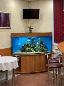 a large aquarium in a room with a table and chairs at Eurohotel Central in Yekaterinburg