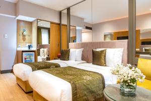 a hotel room with two beds and a table at Oran Hotel in Istanbul +37 photos